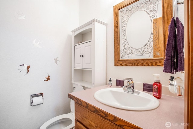 bathroom with vanity and toilet