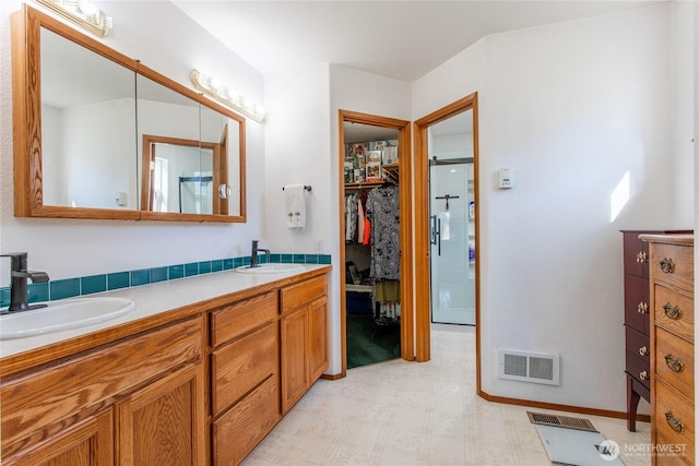 full bath with double vanity, visible vents, a sink, and tile patterned floors