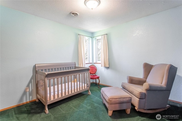 bedroom with a textured ceiling, visible vents, baseboards, a nursery area, and carpet