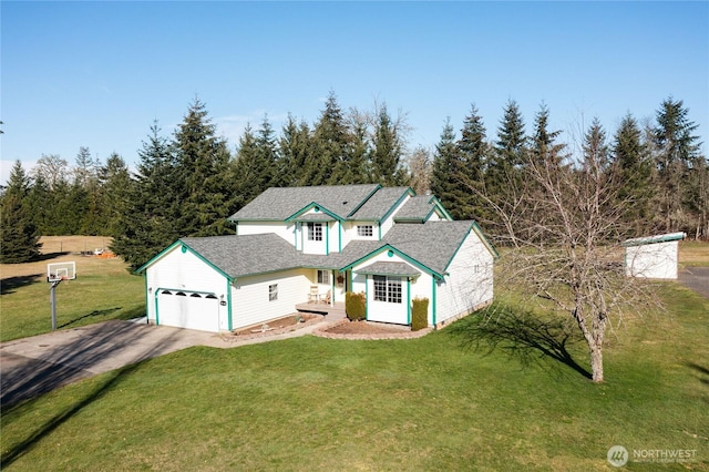 traditional-style house with an attached garage, driveway, and a front yard