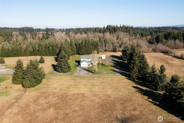 birds eye view of property with a view of trees