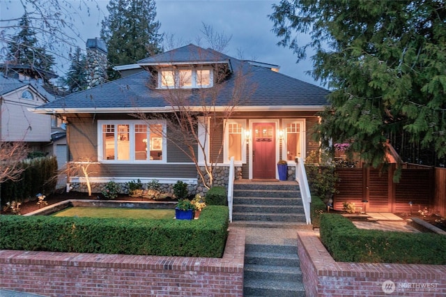 bungalow-style house featuring roof with shingles