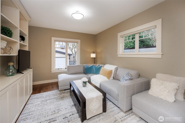 living room featuring baseboards and light wood-style floors