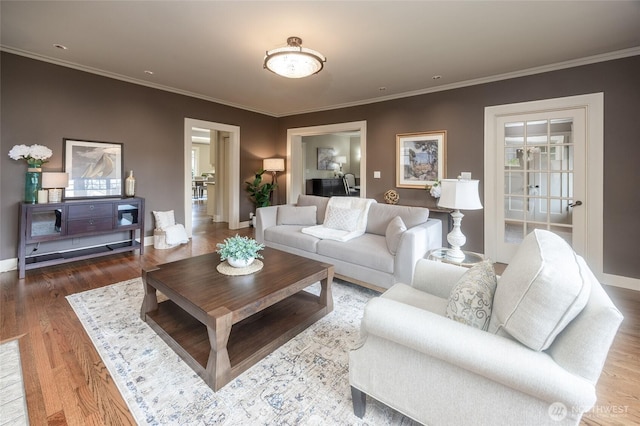 living area featuring ornamental molding, wood finished floors, and baseboards