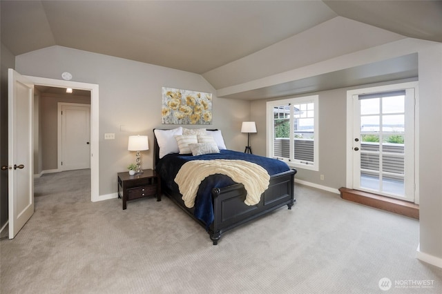 bedroom featuring access to exterior, lofted ceiling, and light colored carpet