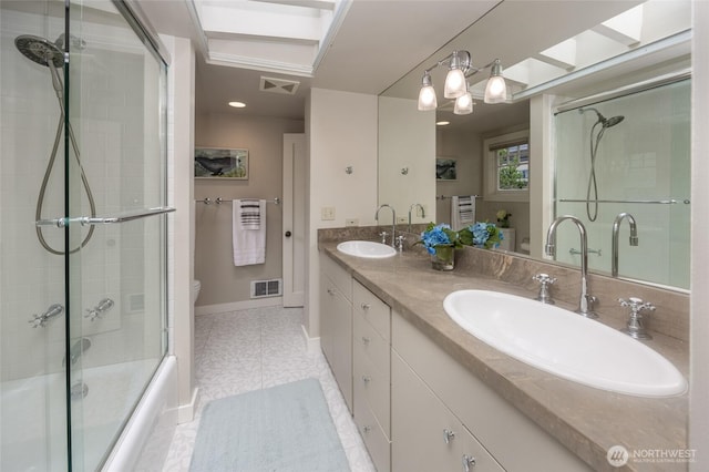 bathroom with visible vents, a sink, and toilet