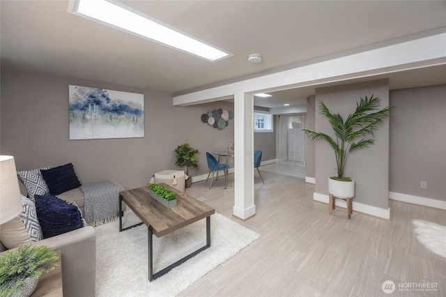 living area with light wood-style flooring and baseboards