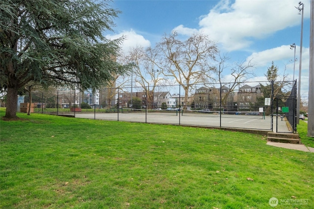 exterior space with a gate, a residential view, fence, and a yard