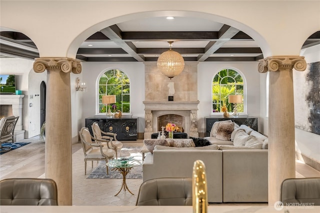 living area with coffered ceiling, beam ceiling, and a high end fireplace