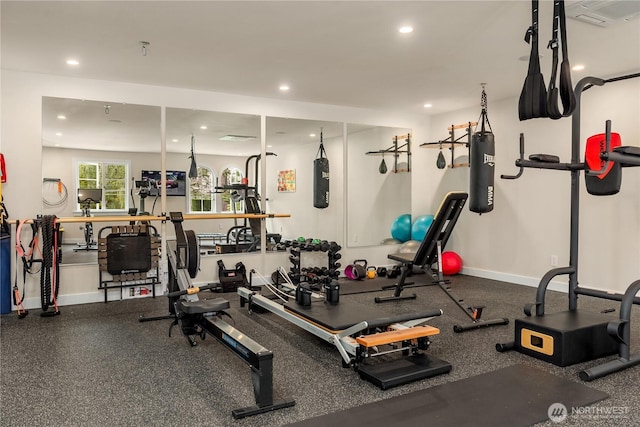 exercise room with baseboards and recessed lighting