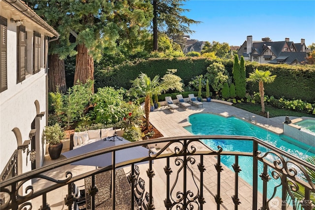 view of swimming pool with a patio area and a pool with connected hot tub