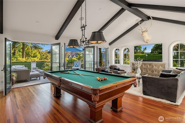 rec room featuring beamed ceiling, wood finished floors, and a wealth of natural light