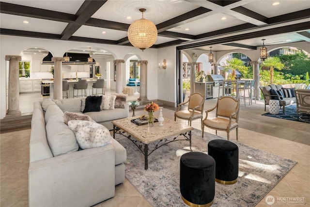 living room with arched walkways, beam ceiling, decorative columns, recessed lighting, and coffered ceiling