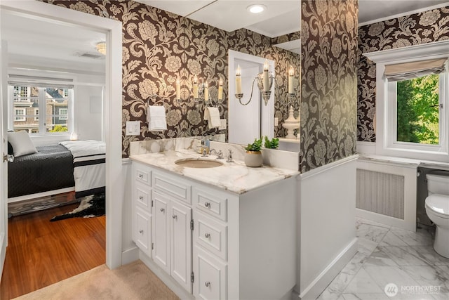 bathroom with marble finish floor, toilet, vanity, ensuite bath, and wallpapered walls