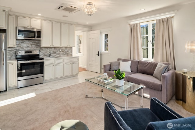 living room featuring a notable chandelier, marble finish floor, visible vents, and recessed lighting