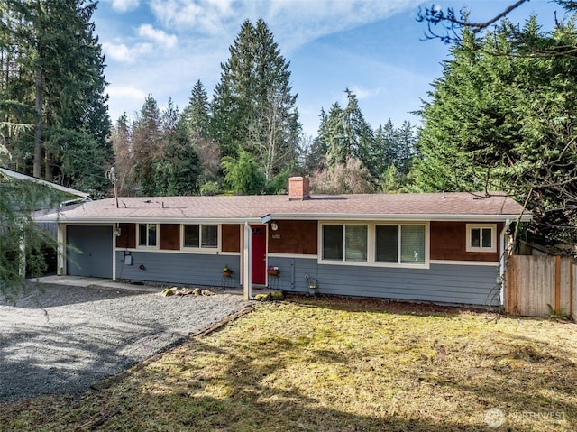 single story home featuring gravel driveway, fence, a chimney, and a front lawn