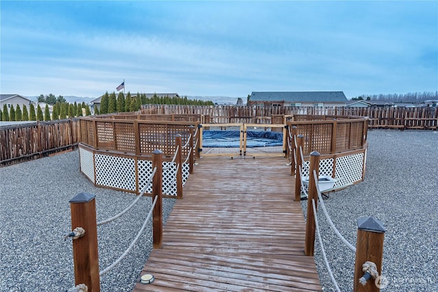 view of dock featuring a fenced backyard