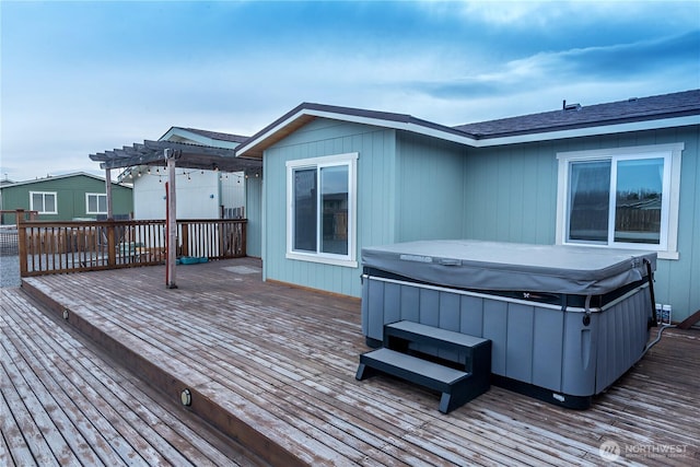 wooden terrace with a pergola and a hot tub