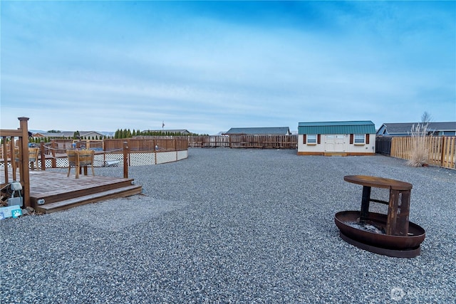 view of dock featuring a deck and a fenced backyard