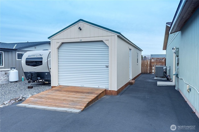 garage featuring cooling unit and fence