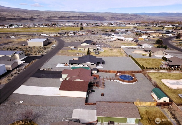 birds eye view of property with a mountain view and a residential view