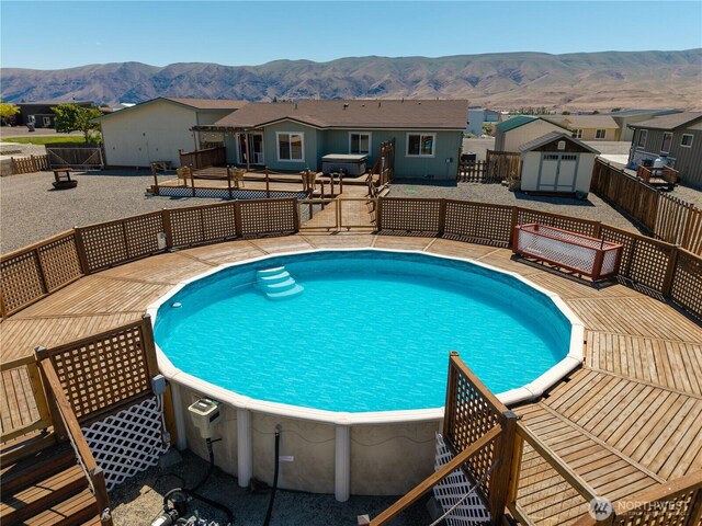 410 Airport Way SW, Mattawa, WA 99349 - outdoor pool featuring a deck with mountain view, a fenced backyard, and a residential view