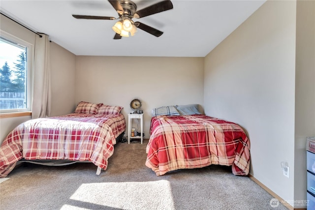 bedroom with carpet, a ceiling fan, and baseboards