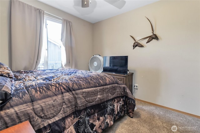 carpeted bedroom with a ceiling fan and baseboards