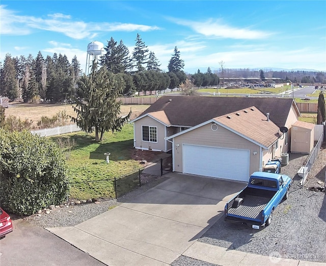 ranch-style house featuring a garage, fence, and concrete driveway