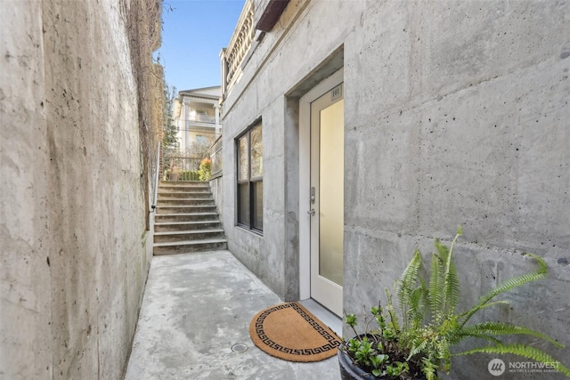 entrance to property with a patio and stucco siding