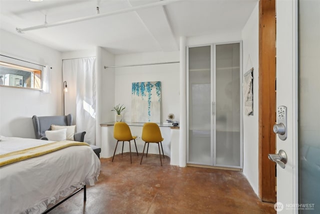 bedroom featuring concrete flooring