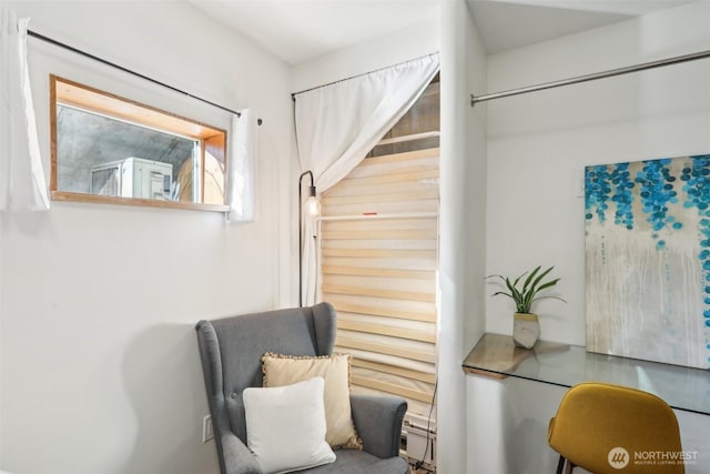 sitting room with a baseboard heating unit