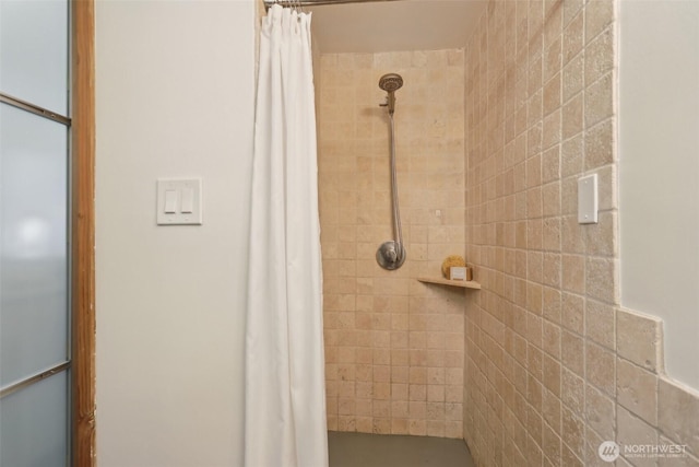 bathroom with a tile shower