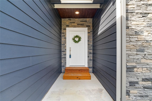 doorway to property with stone siding