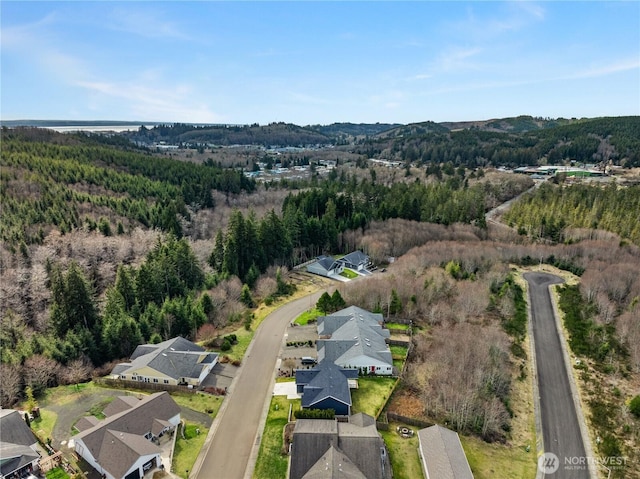 aerial view with a wooded view and a residential view