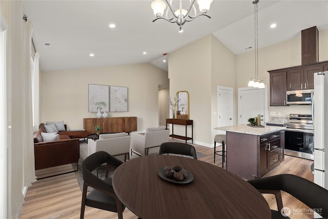 dining space featuring recessed lighting, light wood-style flooring, visible vents, and a chandelier