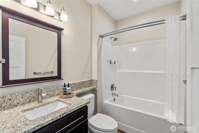 full bathroom featuring vanity, shower / bath combination with curtain, and toilet