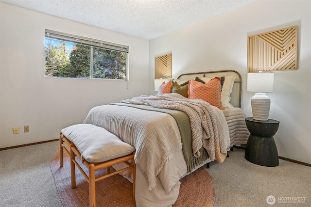 carpeted bedroom featuring a textured ceiling and baseboards