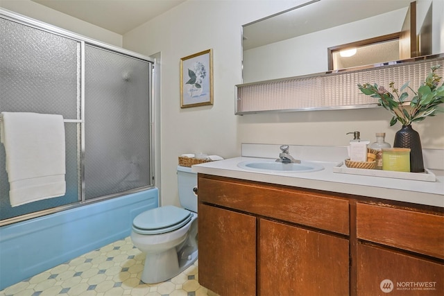 bathroom featuring vanity, toilet, and enclosed tub / shower combo