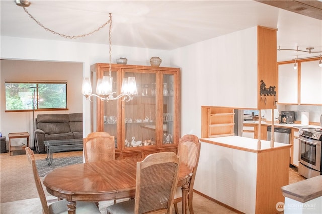 dining area featuring light carpet and a chandelier