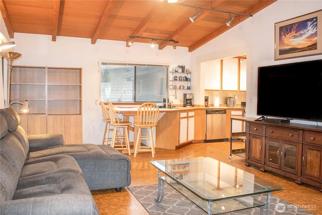 living area featuring lofted ceiling with beams, wood ceiling, and track lighting