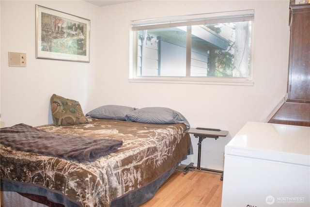 bedroom with light wood finished floors