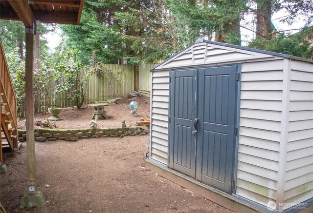 view of shed with fence