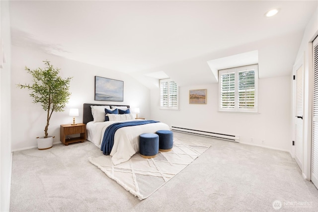 bedroom with carpet floors, baseboards, and baseboard heating