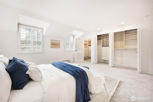 carpeted bedroom featuring multiple closets, a baseboard radiator, recessed lighting, vaulted ceiling, and baseboards