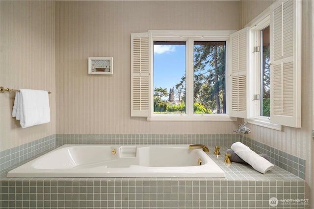 bathroom with wallpapered walls and a garden tub