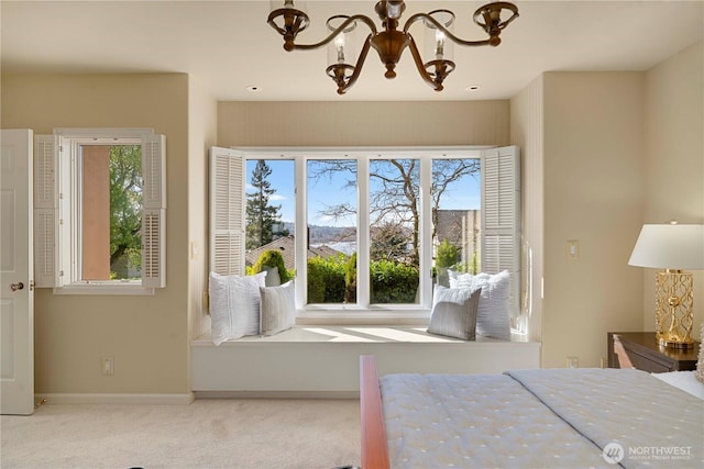 carpeted bedroom featuring baseboards, multiple windows, and an inviting chandelier