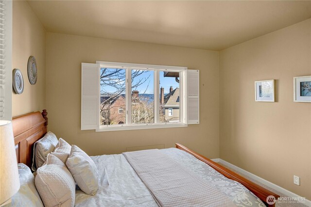 bedroom with wood finished floors and baseboards