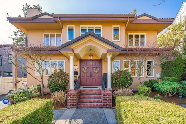 view of front facade featuring a tile roof and stucco siding