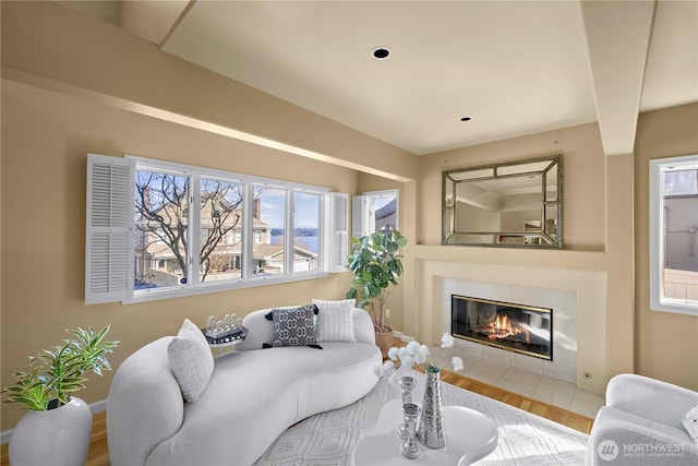 living room with wood finished floors and a fireplace